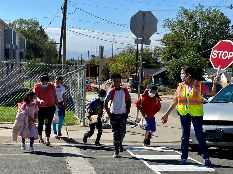 Kids crossing street with crossing guard